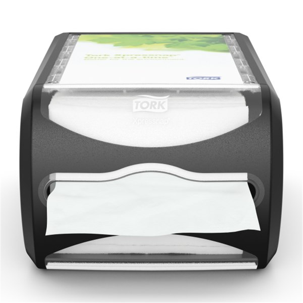 A black tabletop napkin dispenser with a single white napkin partially pulled out from the front slot. Tork Xpressnap® Counter Napkin Dispenser (7.5 in. x 5.7 in. x 12.1 in., 1/Case)